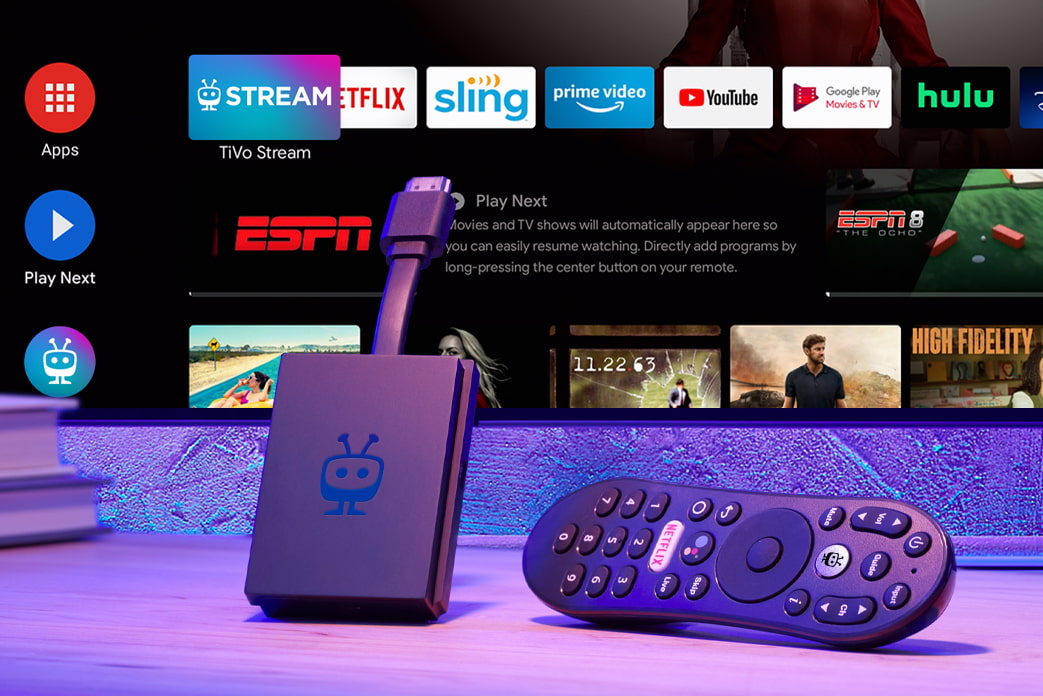 An image of the TiVo Stream 4K plus remote. A TV with the Stream 4K running hangs in the background.