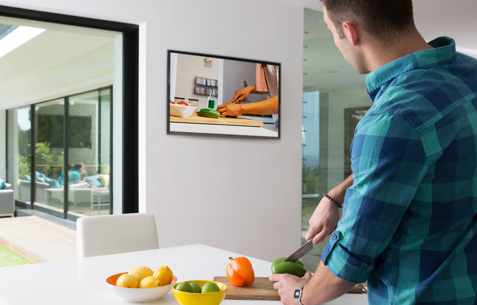 guy in kitchen watching recorded show