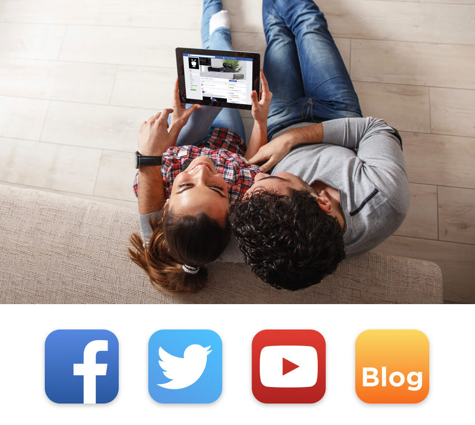 Two adults on the floor playing on a tablet